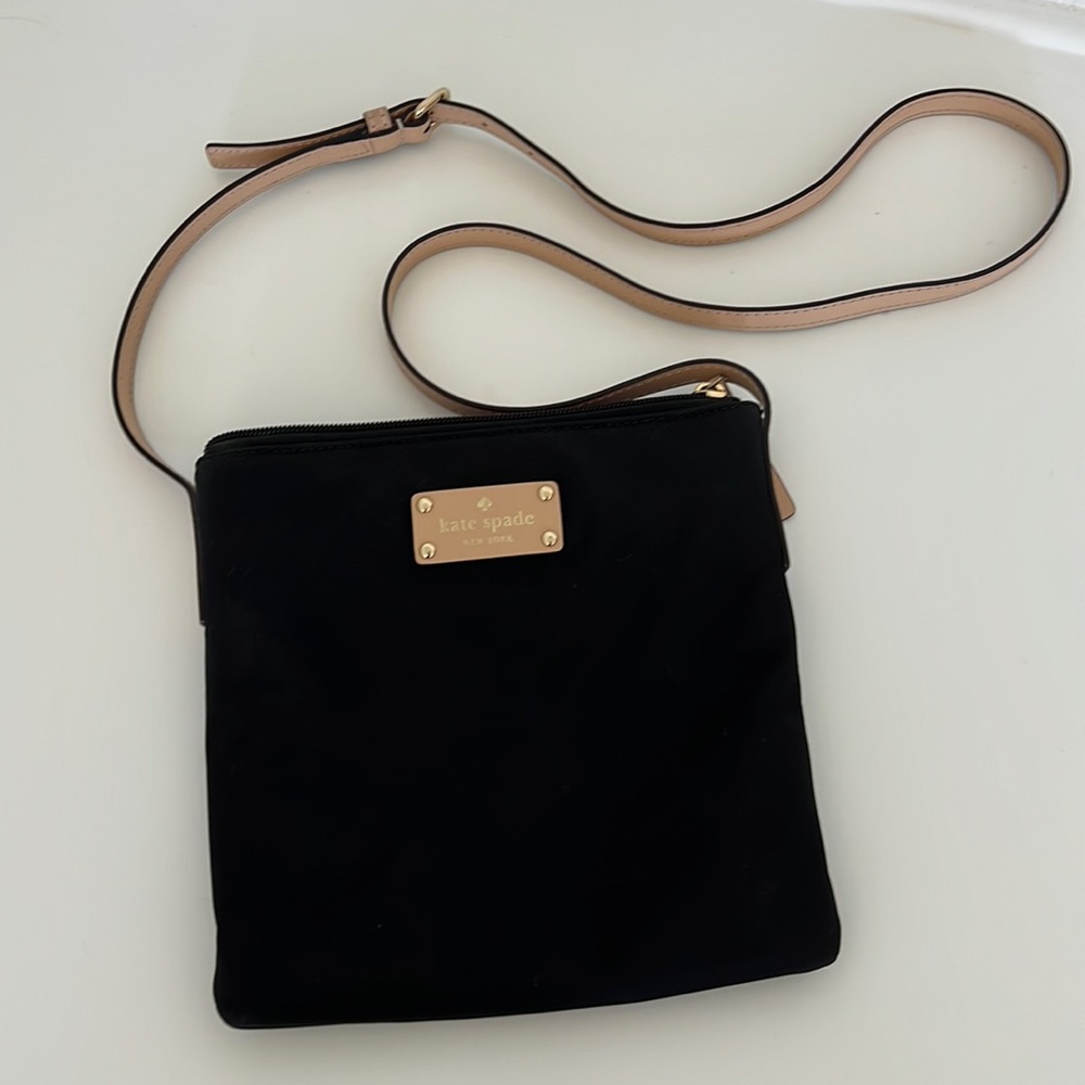 Kate Spade super cute Cross Body bag. Nylon black material wipes clean easily.